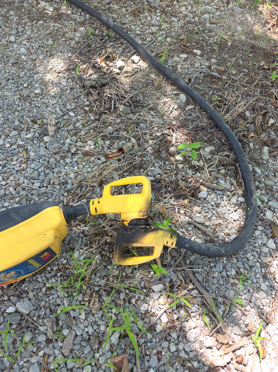 50 amp RV shore-power cord and surge protector melted together by a lightning strike
